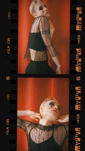 Expressive artistic portrait featuring dramatic makeup and vintage film effect, showcasing unique style.